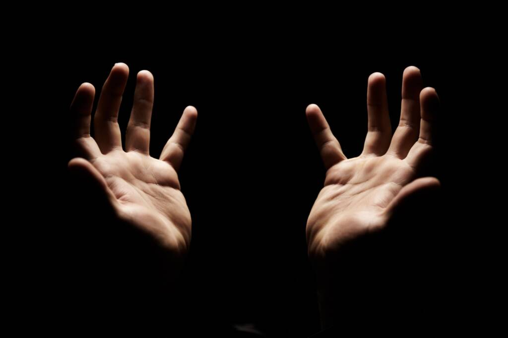 Praising and thanking God. Hands open in praise towards God.