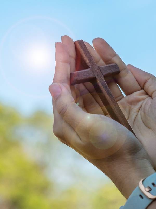 hand holding wood cross, pray for blessings from God. Christian Religion, Crucifix and Faith concept hand holding wood cross, pray for blessings from God. Christian Religion, Crucifix and Faith concept